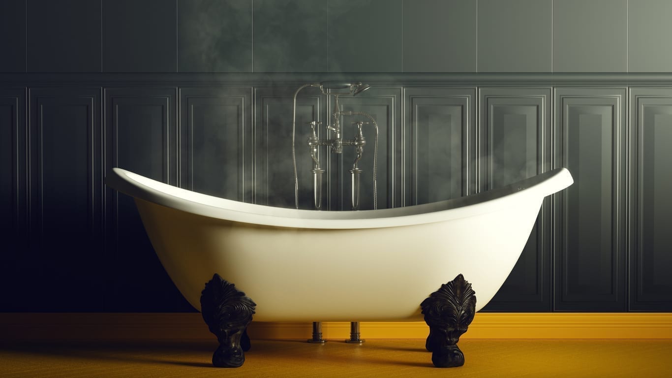 Steamy Dark Blue and Yellow Bathroom With Iron Bath