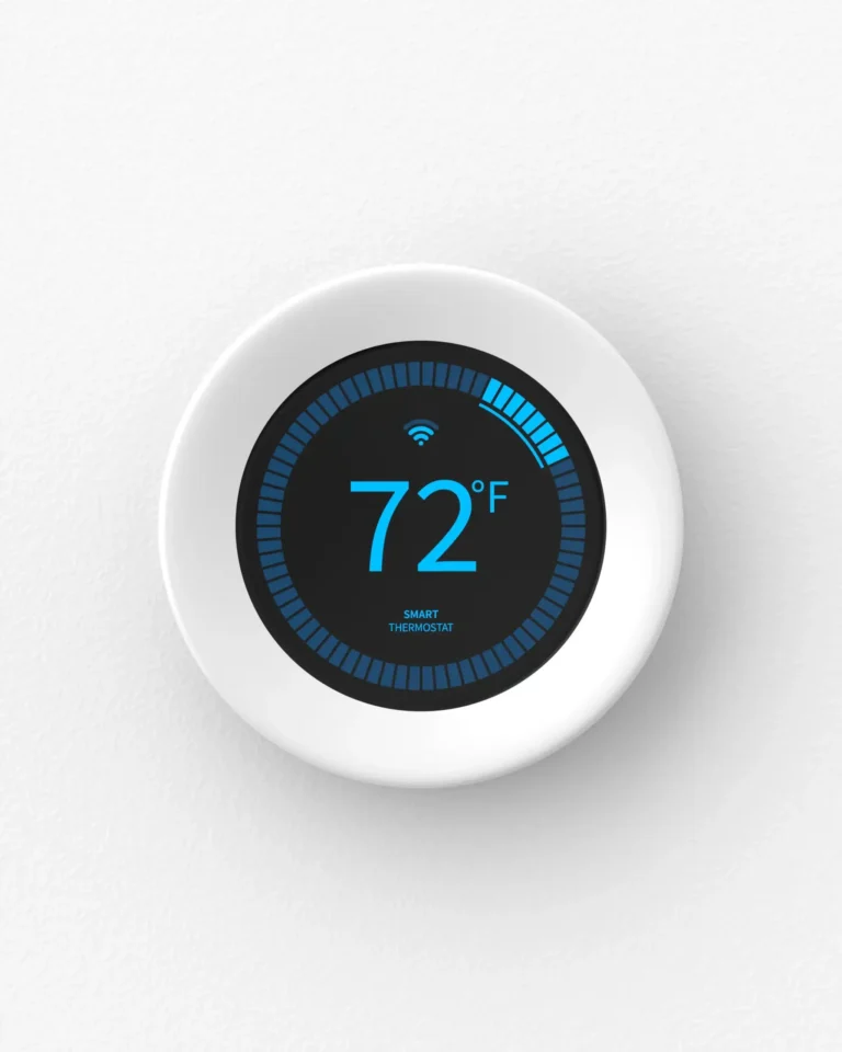 A smart thermostat, expertly integrated during the air conditioning installation, displays 72°F on a circular screen with blue indicators, elegantly mounted on a white wall.
