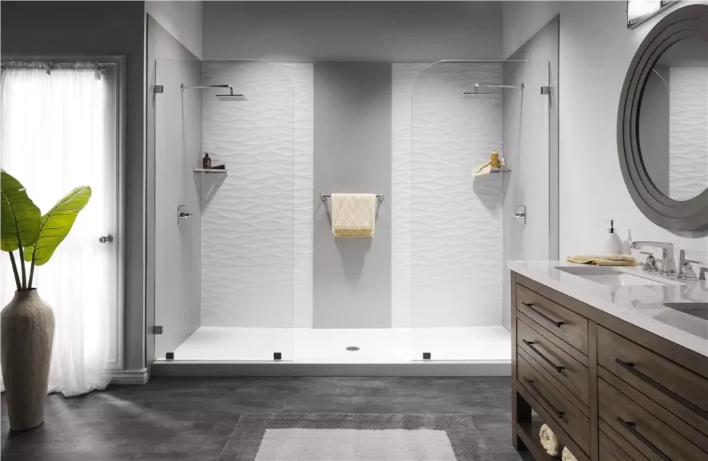 Modern Bathroom Featuring A Large Glass-Enclosed Shower, Dual Showerheads, A Textured White Wall, Gray Flooring, A Wooden Vanity With Sink, And A Potted Plant Near A Window With Sheer Curtains.