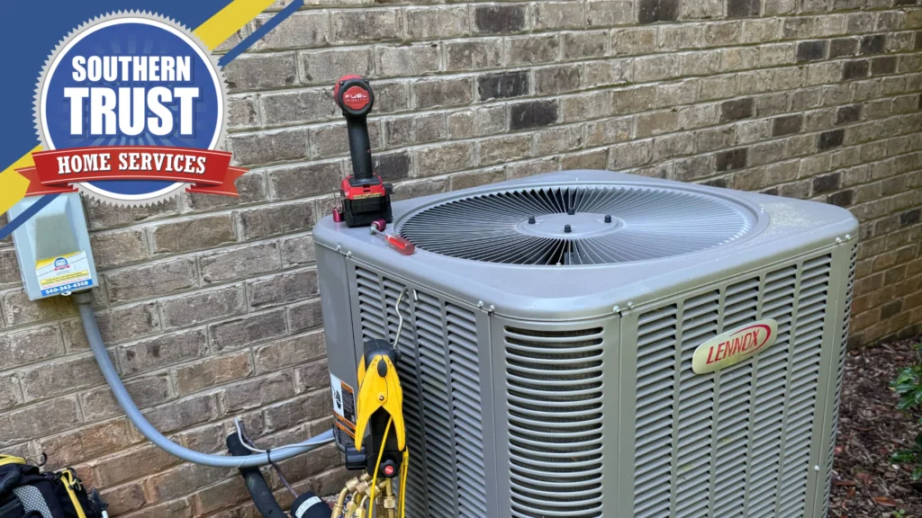 A Lennox Outdoor Air Conditioning Unit Being Serviced With Tools Beside A Brick Wall. A Southern Trust Home Services Logo Appears In The Top Left Corner.